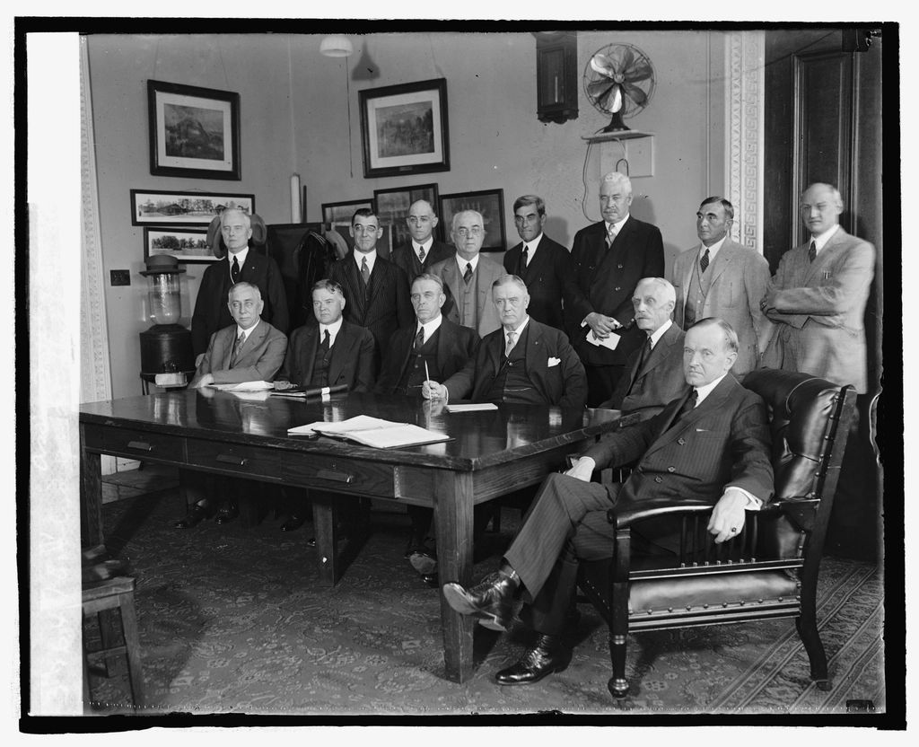 A meeting room with a long table and chairs